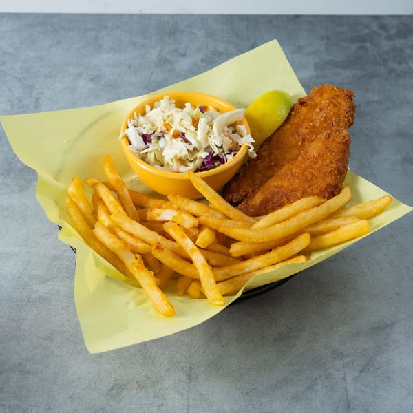 Golden-brown fried fish, french fries, and coleslaw in a yellow bowl, served in a basket.
